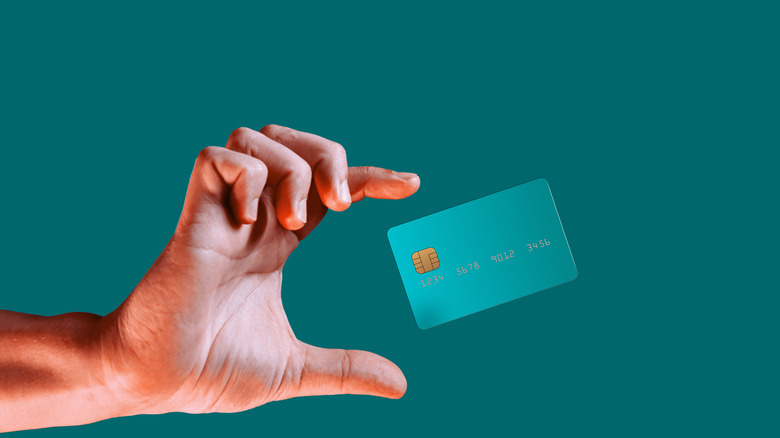 Hand reaching for credit card