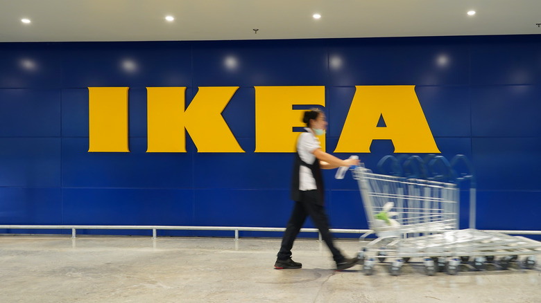 woman pushes carts outside Ikea