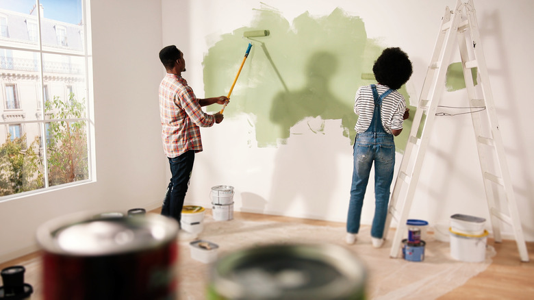 couple painting wall