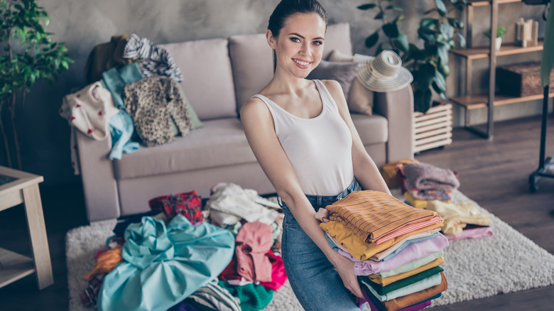 Woman separating clothes into piles