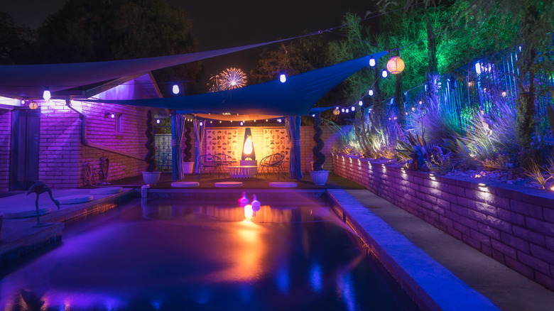 A pool at night featuring several kinds of colored lights