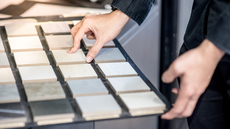 person looking at flooring samples