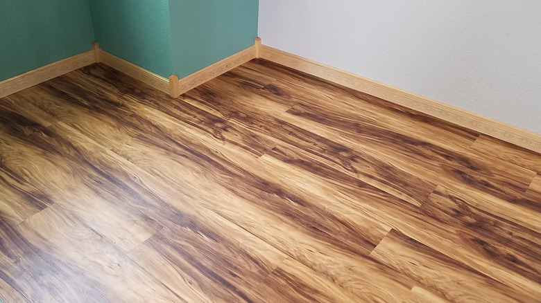 Small room with wood-look flooring featuring boldly striped wood grain.