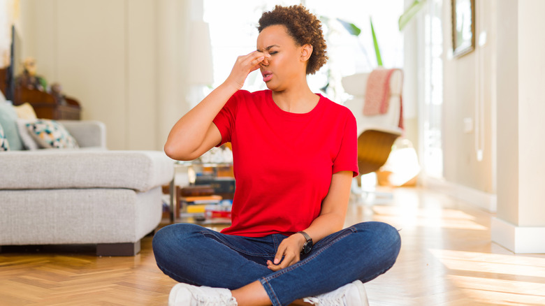 Woman pinching her nose