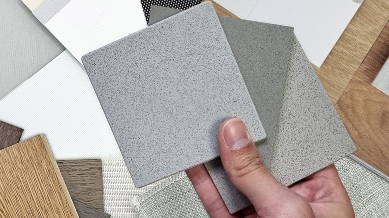 Hand holding stone vinyl designs