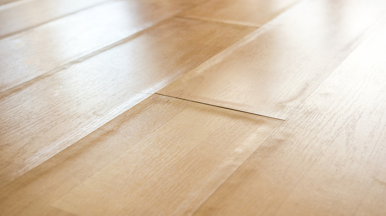 Laminate flooring that has been warped by humidity and temperature fluctuations