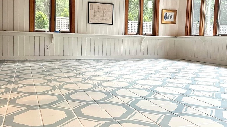 A tiled floor painted with an octagon geometric shape in baby blue.