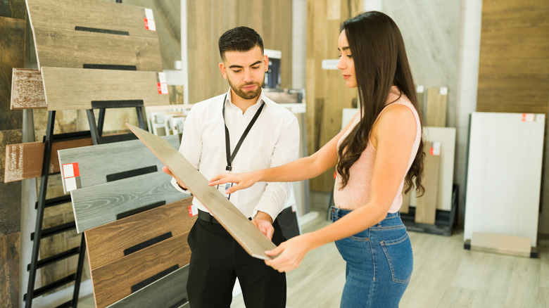 Salesperson speaking with a client about buying floors at the furniture store