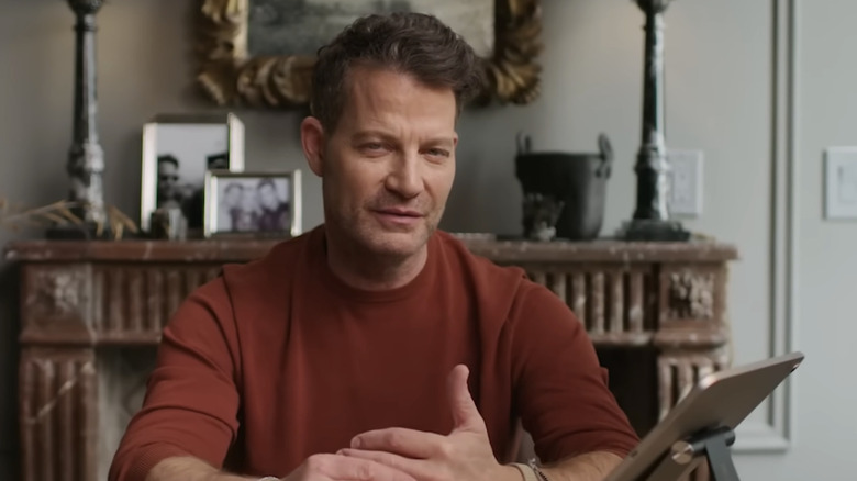 Nate Berkus in front of his fireplace in his own living room.