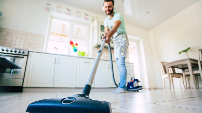 Person vacuuming the kitchen