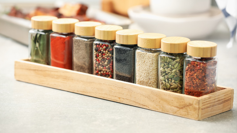 Spices in a low wooden box for organizing