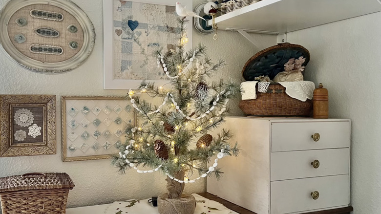 A little Christmas tree decorated with handmade white button garland