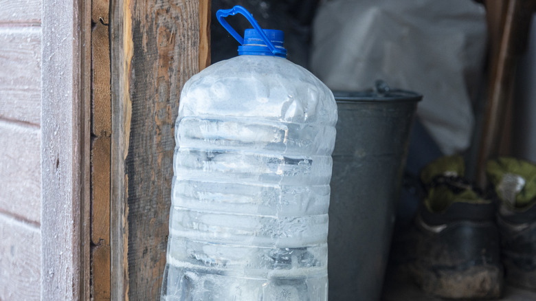 Frozen water jug in doorway