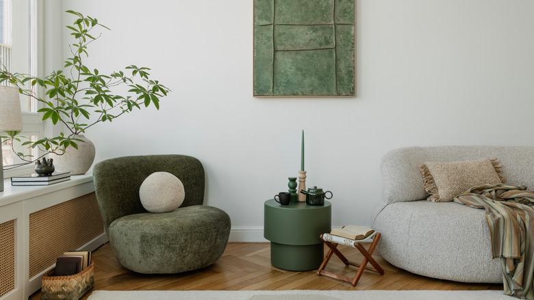 Living room with dark green, rounded accent chair