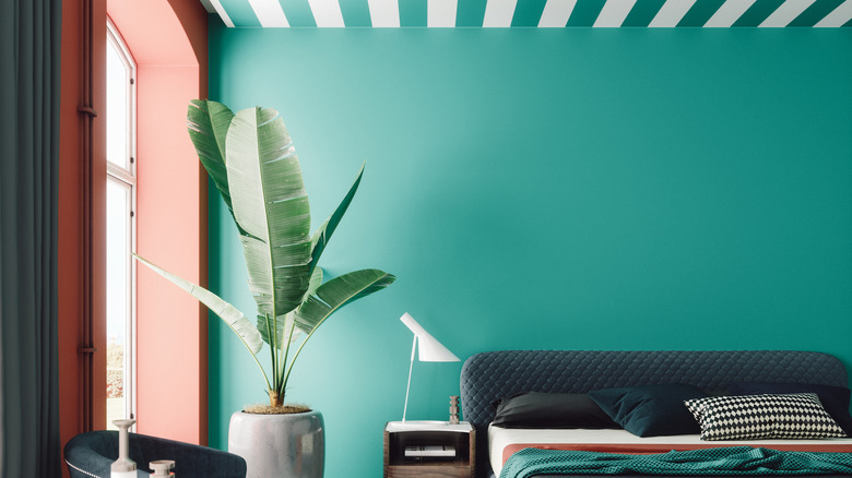Bold, dopamine decor inspired room with green walls and peach trim