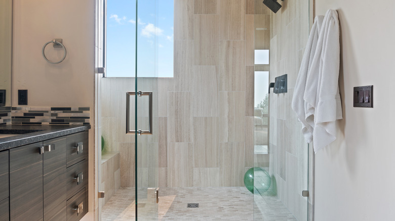 A glass walk in shower in a luxurious bathroom