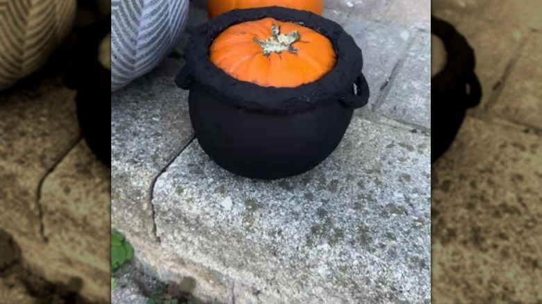 Halloween cauldron made out of a pumpkin
