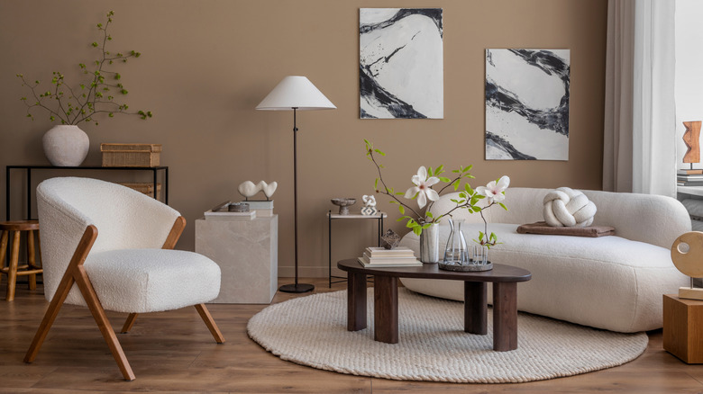 Room with white bouclé armchair and sofa