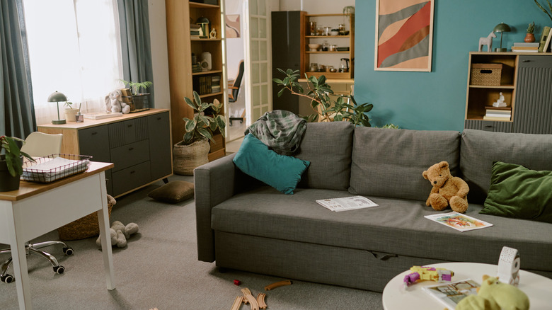 Cluttered and messy living room with office space.