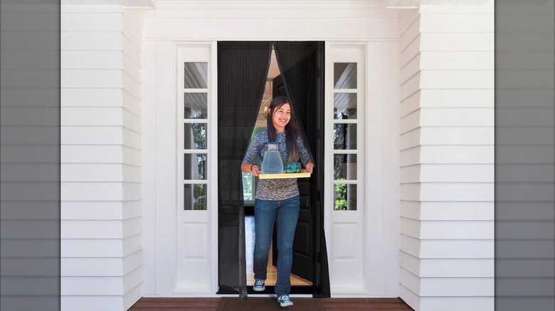 Woman walking through Harbor Freight screen door