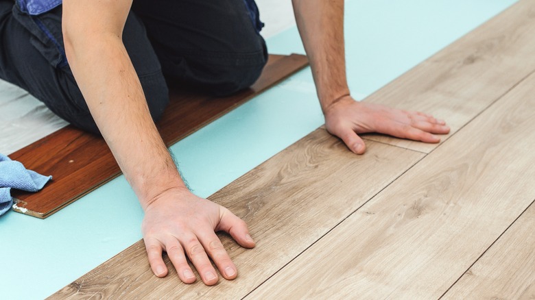 Person installing laminate flooring