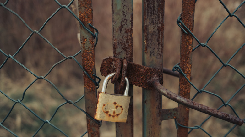 Rusted garden gate with rusted key lock