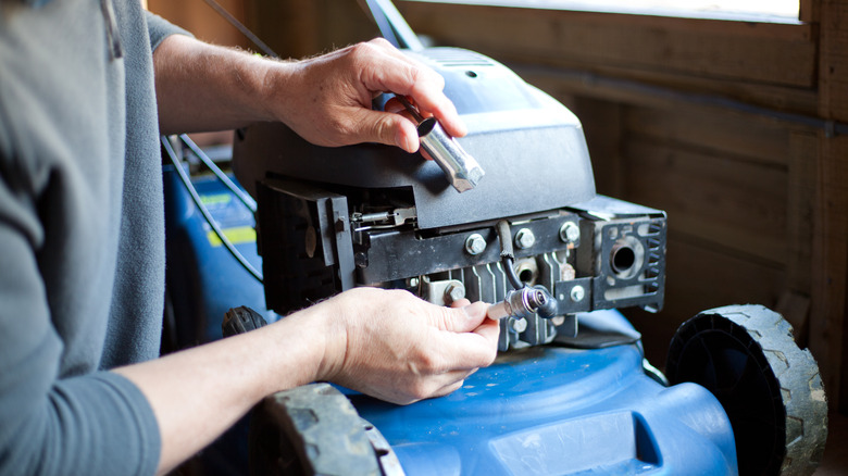 a man working on maintaining a lawn mower