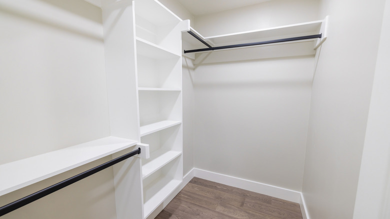 An empty closet with built-in shelving