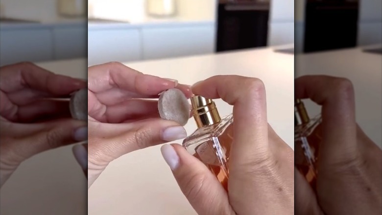 person spraying perfume on felt furniture pad
