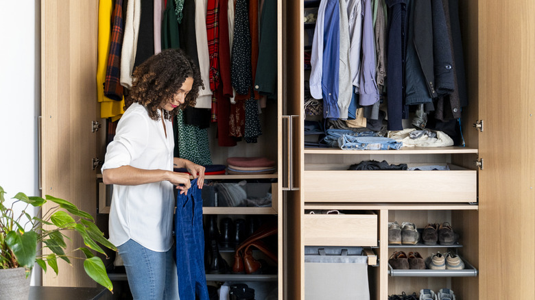Woman organizing clothes in her closet
