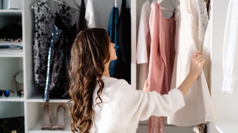 person looking through closet