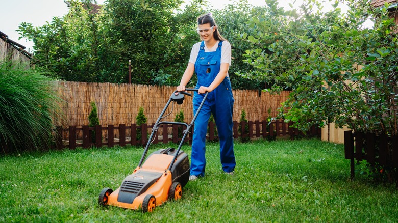 Woman mowing the lawn