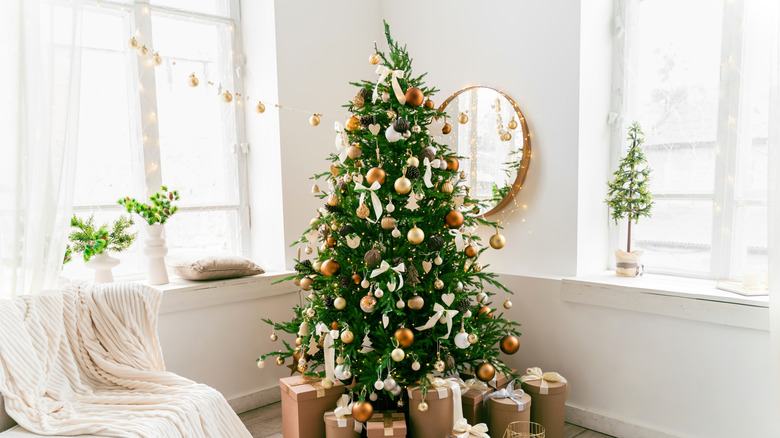 A decorated Christmas tree in a white living room