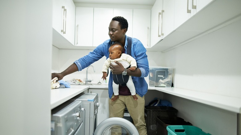 dad with child in a small laundry room