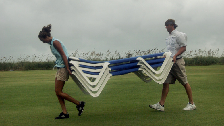 moving patio furniture before storm