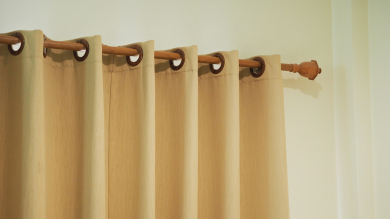 Pleated beige grommet curtains