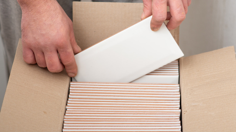 Man taking out tile from box