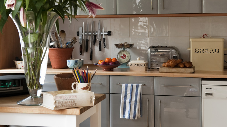 Kitchen with glossy gray cabinets and colorful decor