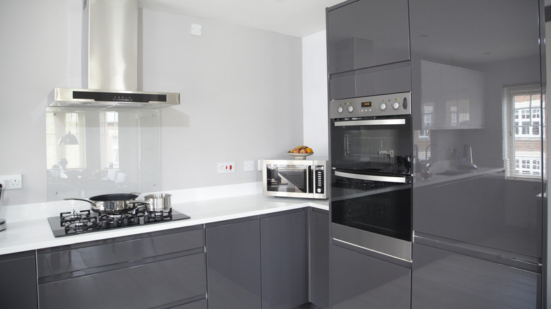 Gray glossy cabinets in a minimalist kitchen