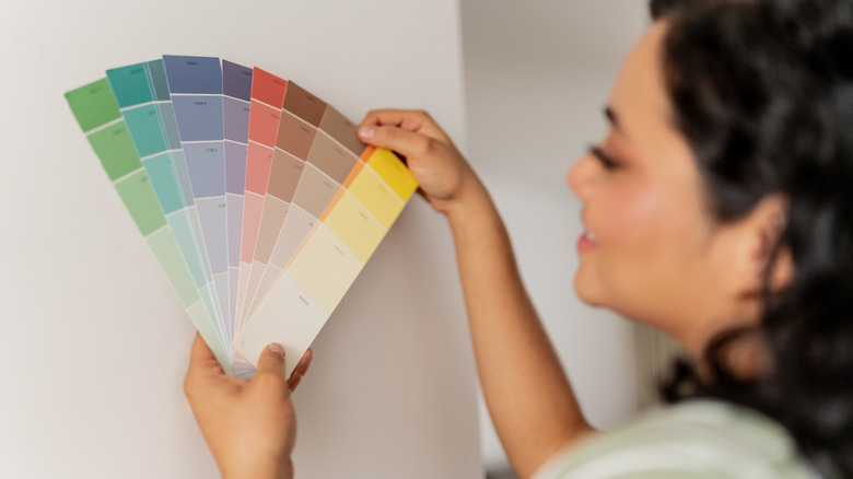 Someone looking at different paint colors