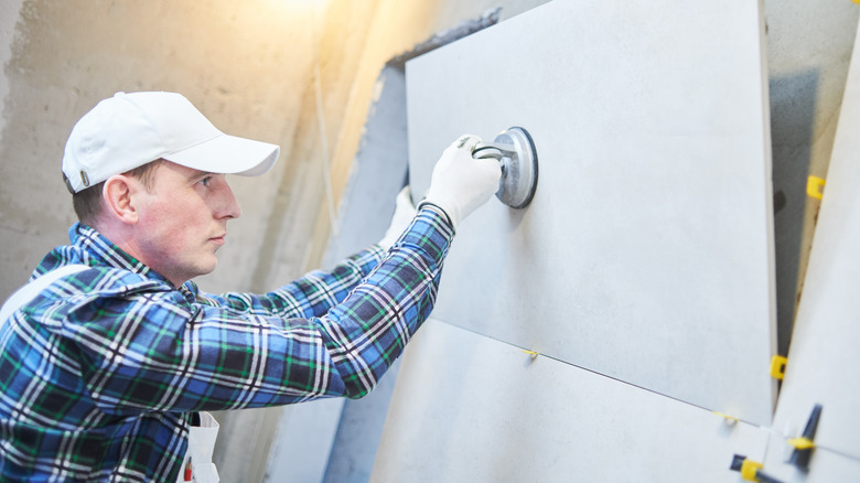 Man installing bathroom tile