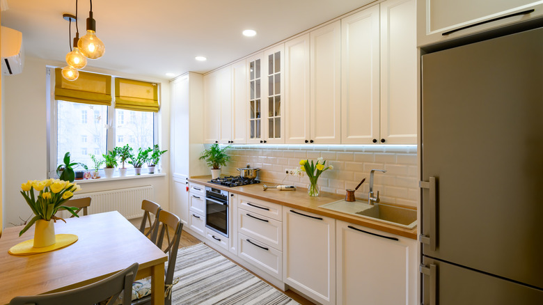 Beautiful modern kitchen with butter yellow cabinets