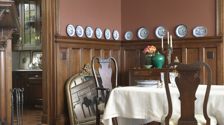 Craftsman-era dining room with wood paneling and a plate rack.