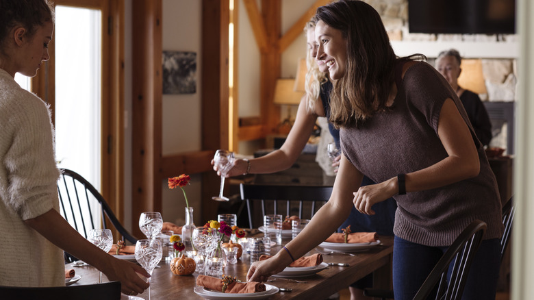 A few people setting a table