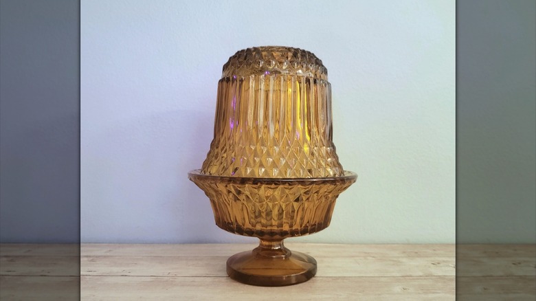 Amber yellow fairy lamp on wood table