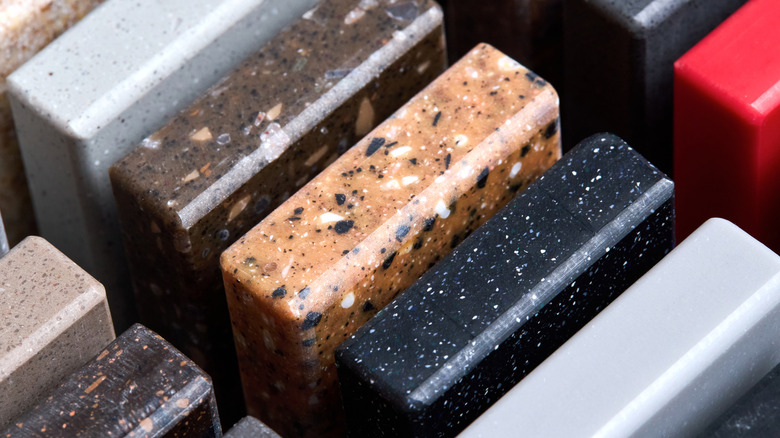 Small samples of granite in dark blue, light brown, brown, and gray