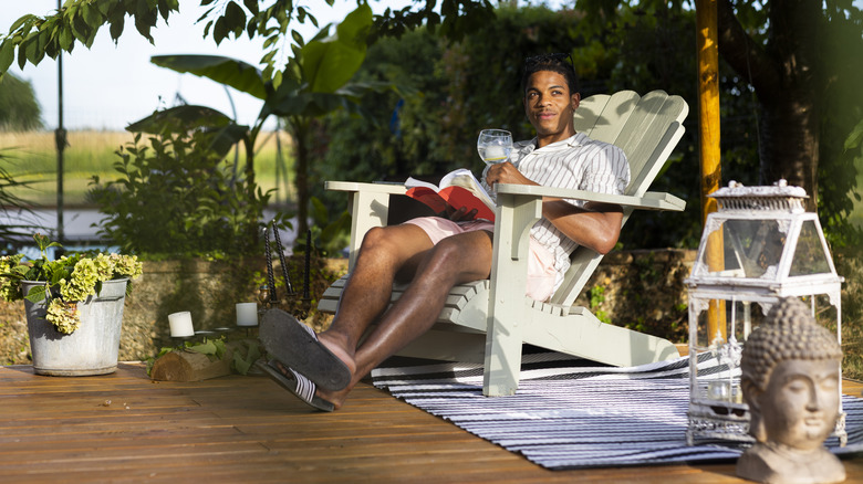 Man drinking on their patio 