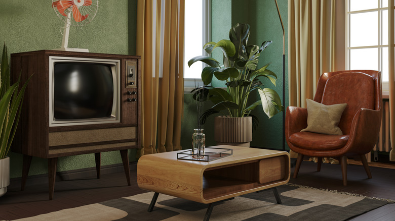 retro styled 1970s living room with vintage tv and rounded armchair