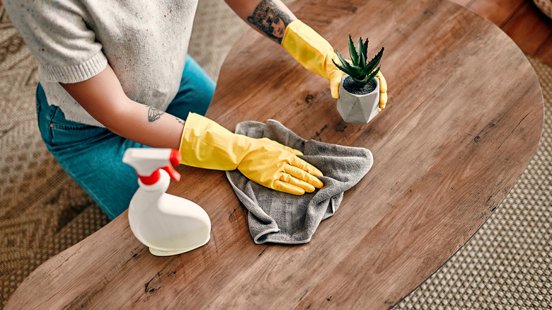 Person dusting table