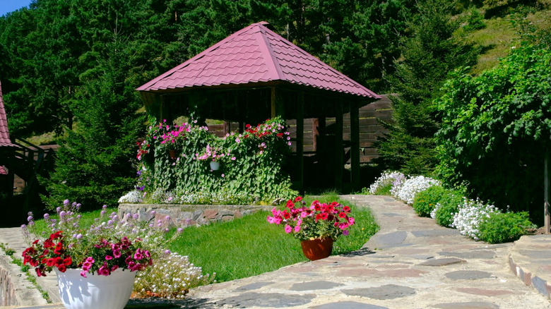 A pretty landscaped garden with a gazebo and lots of flowering plants
